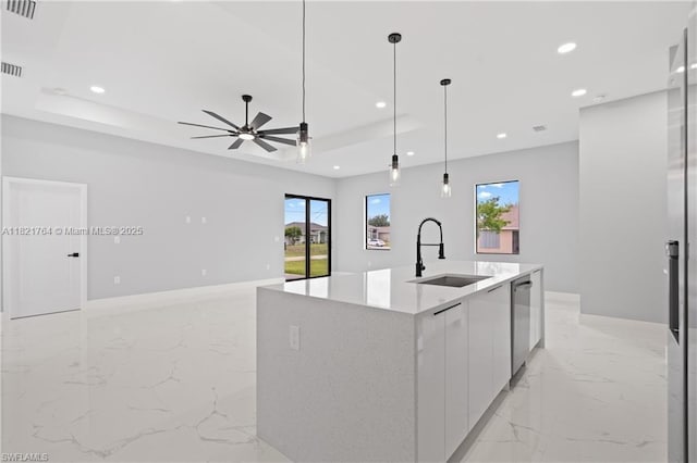 1003 Casino Ave, Lehigh Acres, FL 33971 - kitchen featuring modern cabinets, a tray ceiling, light marble finish floors, stainless steel dishwasher, and a center island with sink