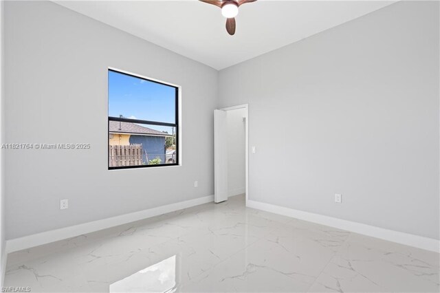 1003 Casino Ave, Lehigh Acres, FL 33971 - empty room with marble finish floors and ceiling fan