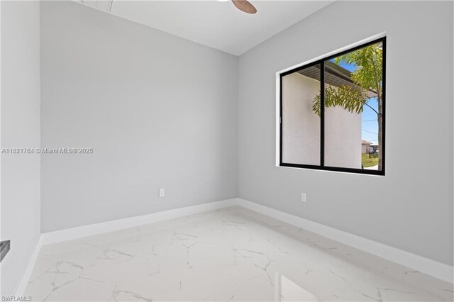 1003 Casino Ave, Lehigh Acres, FL 33971 - empty room featuring marble look tile flooring and a ceiling fan