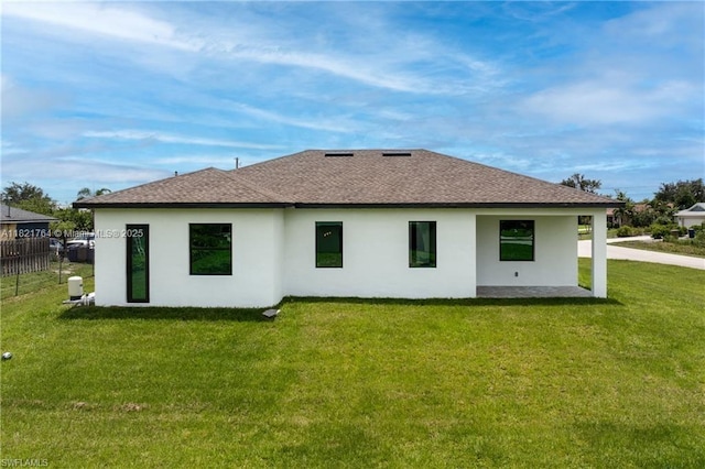 1003 Casino Ave, Lehigh Acres, FL 33971 - rear view of house featuring a shingled roof and stucco siding