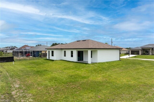 1003 Casino Ave, Lehigh Acres, FL 33971 - back of property featuring stucco siding and a shingled roof