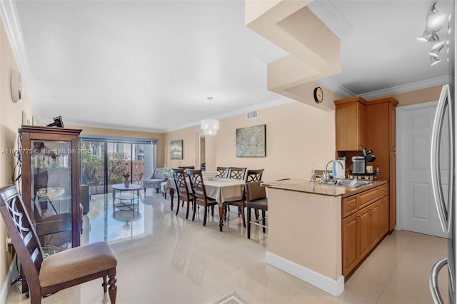 460 W Park Dr Unit 104, Miami, FL 33172 - kitchen with ornamental molding, light tile patterned flooring, fridge, decorative light fixtures, and brown cabinetry