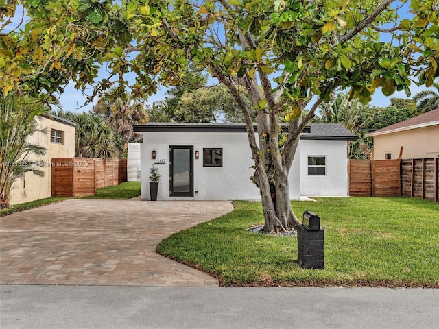 107 Central Ave, Delray Beach, FL 33483 - view of front of house featuring stucco siding and a gate