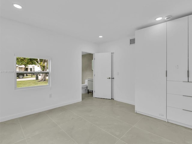 107 Central Ave, Delray Beach, FL 33483 - unfurnished bedroom with recessed lighting, light tile patterned floors, and ensuite bathroom