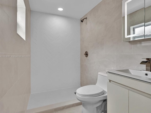 107 Central Ave, Delray Beach, FL 33483 - bathroom featuring tile walls, a tile shower, vanity, recessed lighting, and tile patterned flooring