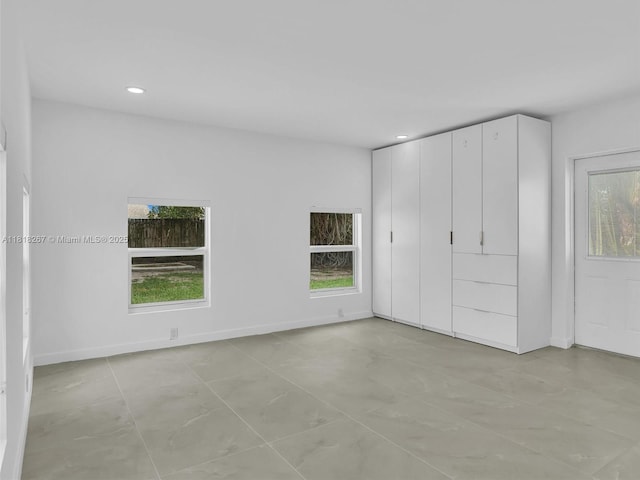 107 Central Ave, Delray Beach, FL 33483 - unfurnished bedroom with multiple windows, recessed lighting, and light tile patterned flooring