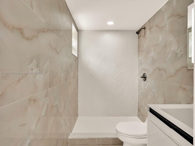 107 Central Ave, Delray Beach, FL 33483 - bathroom featuring vanity, a tile shower, tile walls, and recessed lighting