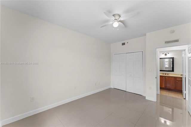 5271 SW 8th St Unit 213, Miami, FL 33134 - unfurnished bedroom with a closet, light tile patterned floors, and a ceiling fan