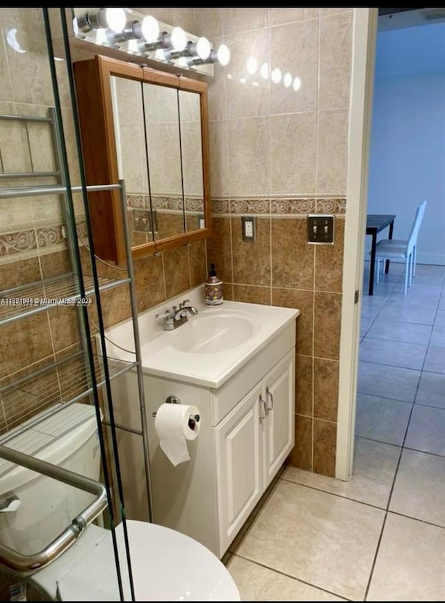 1965 S Ocean Dr Unit 5B, Hallandale Beach, FL 33009 - bathroom with tile walls, vanity, and tile patterned flooring