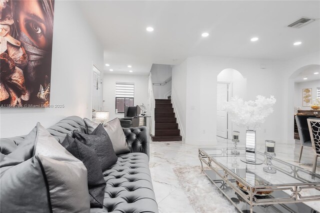 8885 NW 100th Pl, Doral, FL 33178 - living area featuring arched walkways, recessed lighting, marble tiled floors, and stairs