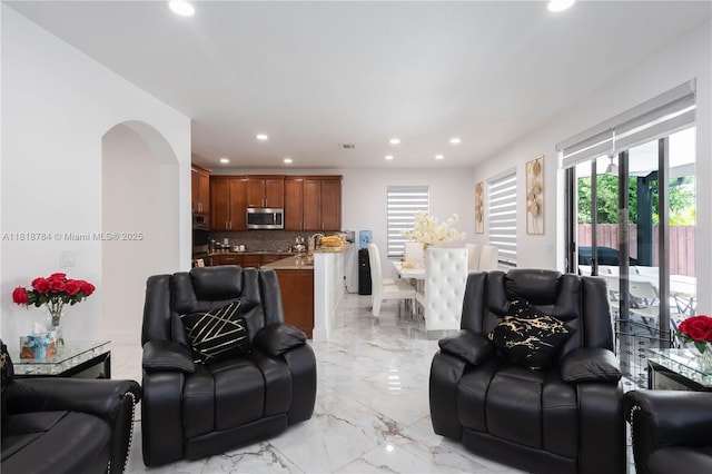 8885 NW 100th Pl, Doral, FL 33178 - living room featuring recessed lighting, light marble finish floors, and arched walkways