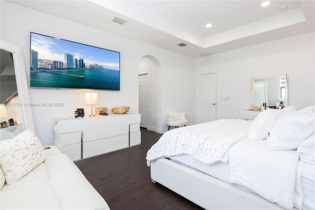 8885 NW 100th Pl, Doral, FL 33178 - bedroom featuring dark wood-type flooring, recessed lighting, arched walkways, and a raised ceiling