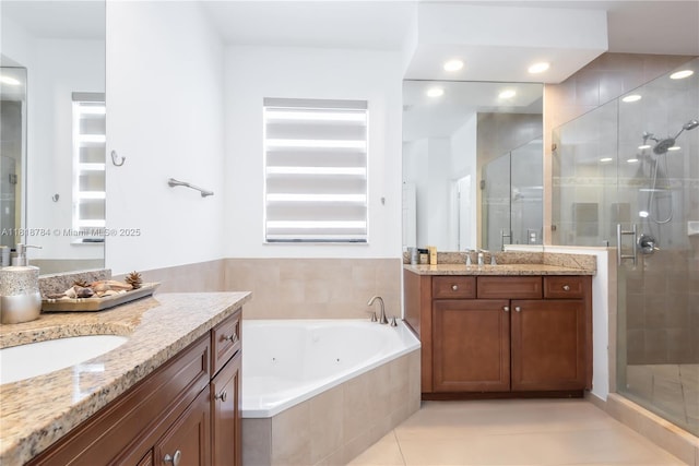 8885 NW 100th Pl, Doral, FL 33178 - full bath featuring two vanities, a shower stall, a whirlpool tub, tile patterned flooring, and recessed lighting