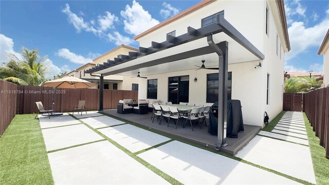 8885 NW 100th Pl, Doral, FL 33178 - rear view of property with a patio, outdoor lounge area, ceiling fan, a fenced backyard, and stucco siding