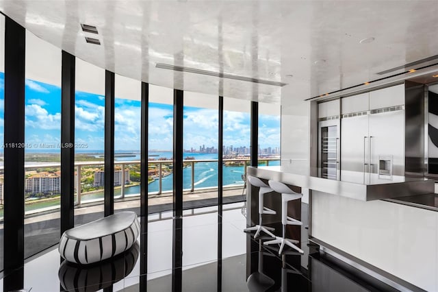 100 S Pointe Dr Unit 3003, Miami Beach, FL 33139 - kitchen featuring a water view, a city view, tile patterned flooring, and expansive windows