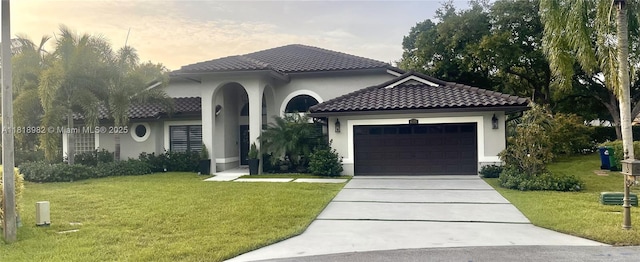 4370 NW 62nd Ter, Coral Springs, FL 33067 - mediterranean / spanish-style home with driveway, a lawn, an attached garage, a tile roof, and stucco siding
