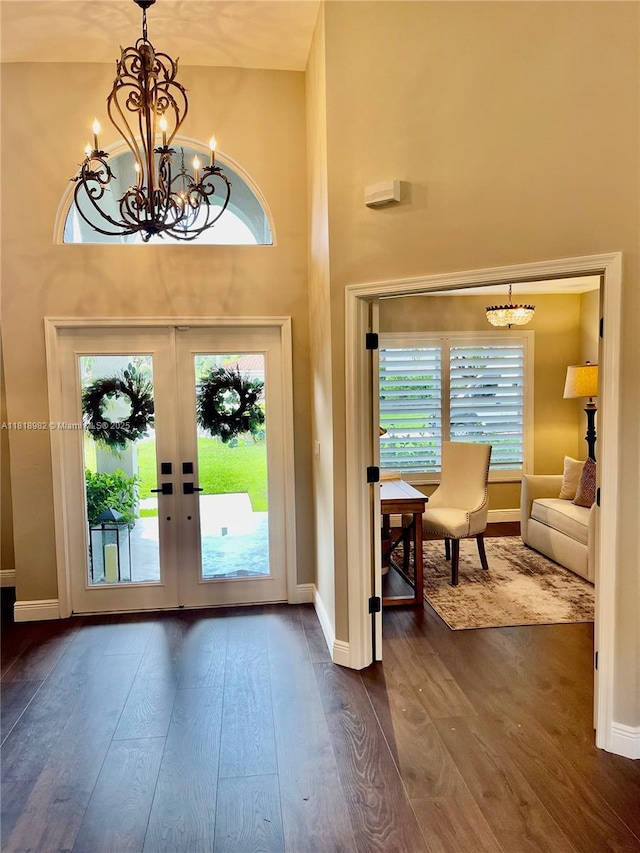 4370 NW 62nd Ter, Coral Springs, FL 33067 - foyer entrance featuring a chandelier, plenty of natural light, dark wood-style floors, a high ceiling, and french doors