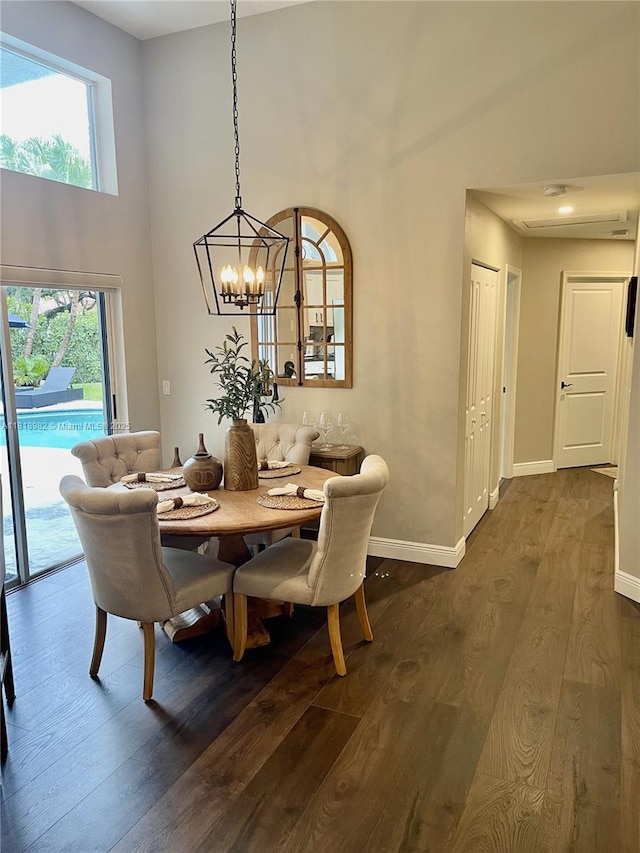 4370 NW 62nd Ter, Coral Springs, FL 33067 - dining area featuring a high ceiling, dark wood-type flooring, and a chandelier