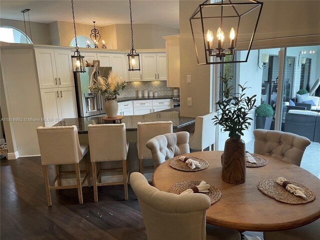 4370 NW 62nd Ter, Coral Springs, FL 33067 - dining space featuring a chandelier, dark wood-type flooring, and vaulted ceiling