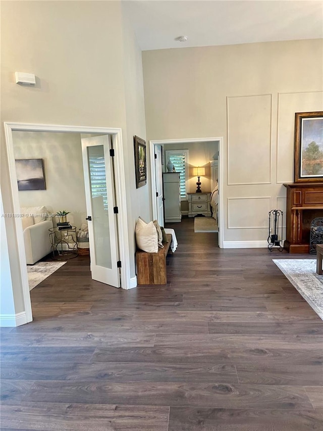 4370 NW 62nd Ter, Coral Springs, FL 33067 - entryway featuring dark wood-style flooring, a towering ceiling, and a fireplace