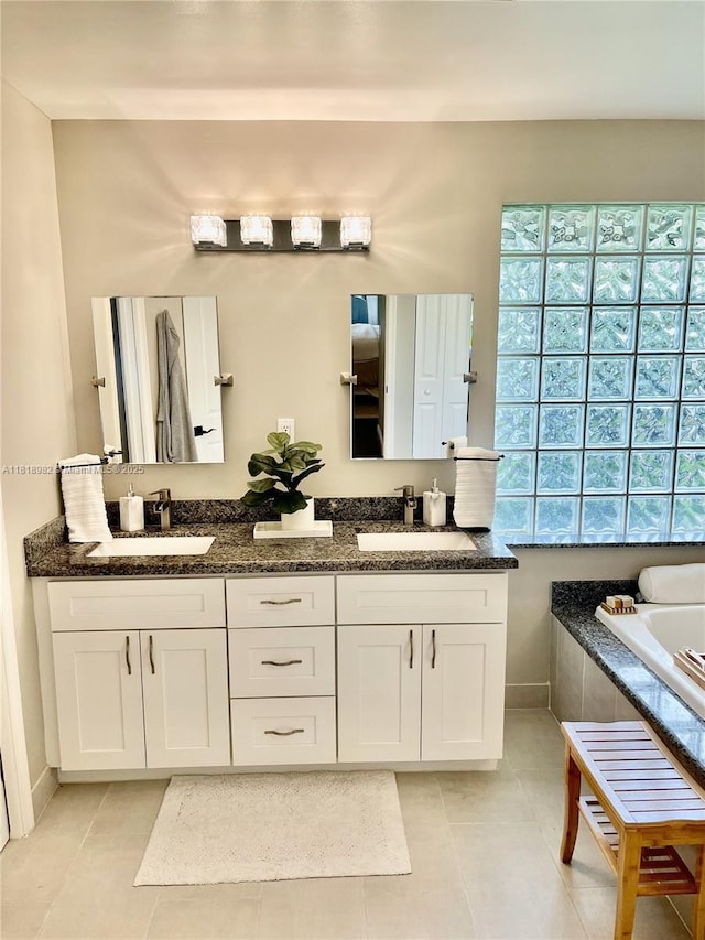 4370 NW 62nd Ter, Coral Springs, FL 33067 - full bath with double vanity, tile patterned floors, and a relaxing tiled tub