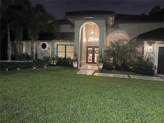 4370 NW 62nd Ter, Coral Springs, FL 33067 - view of front of home with french doors, a yard, and stucco siding