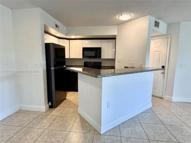 12730 Vista Isles Dr Unit 813, Sunrise, FL 33325 - kitchen with black appliances, dark stone countertops, light tile patterned floors, a textured ceiling, and white cabinetry