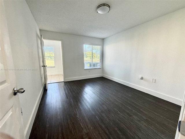 12730 Vista Isles Dr Unit 813, Sunrise, FL 33325 - unfurnished room with dark wood-type flooring and a textured ceiling