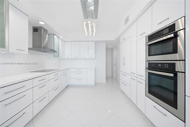 2711 S Ocean Dr Unit 1202, Hollywood, FL 33019 - kitchen with wall chimney exhaust hood, modern cabinets, stainless steel double oven, black electric cooktop, and white cabinets