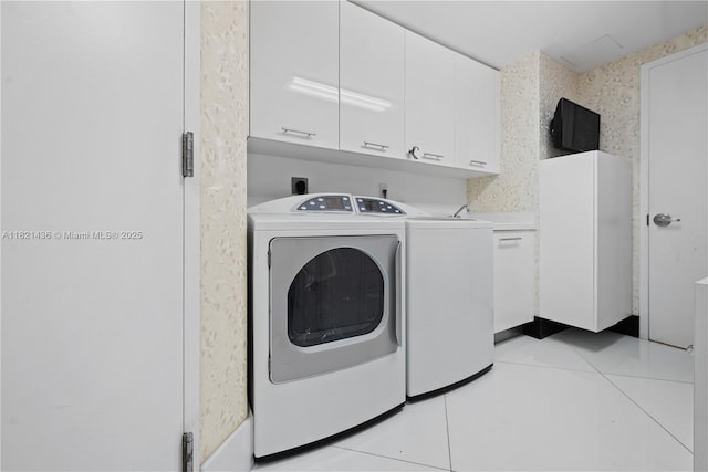 2711 S Ocean Dr Unit 1202, Hollywood, FL 33019 - laundry room with cabinet space, light tile patterned flooring, and washing machine and dryer