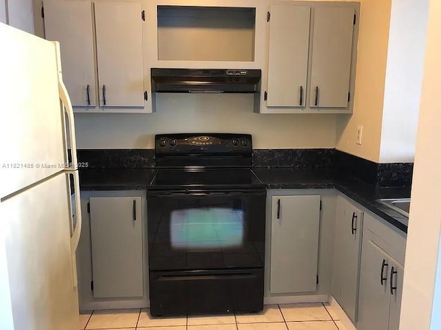 546 SW 1st St Unit 501, Miami, FL 33130 - kitchen featuring freestanding refrigerator, range hood, black / electric stove, dark countertops, and light tile patterned floors