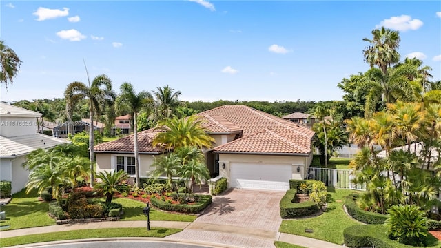 11196 Sea Grass Cir, Boca Raton, FL 33498 - mediterranean / spanish-style house with stucco siding, a garage, a tile roof, decorative driveway, and a residential view