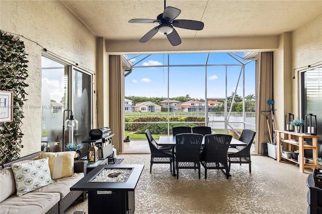 11196 Sea Grass Cir, Boca Raton, FL 33498 - sunroom / solarium with ceiling fan, an outdoor living space with a fire pit, outdoor dining space, and a residential view
