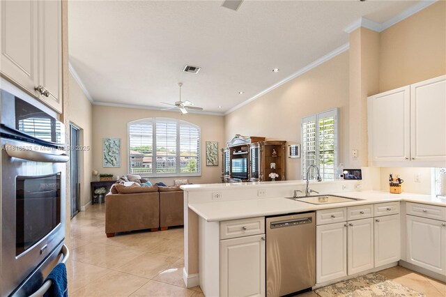 11196 Sea Grass Cir, Boca Raton, FL 33498 - kitchen with appliances with stainless steel finishes, a peninsula, ornamental molding, plenty of natural light, and light tile patterned flooring