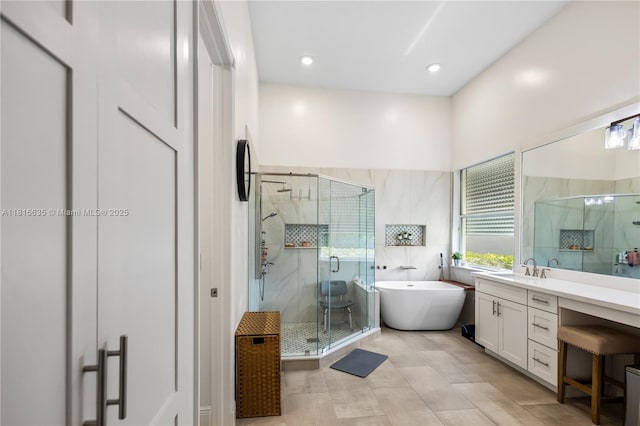 11196 Sea Grass Cir, Boca Raton, FL 33498 - full bathroom with vanity, a shower stall, a freestanding tub, tile patterned flooring, and recessed lighting