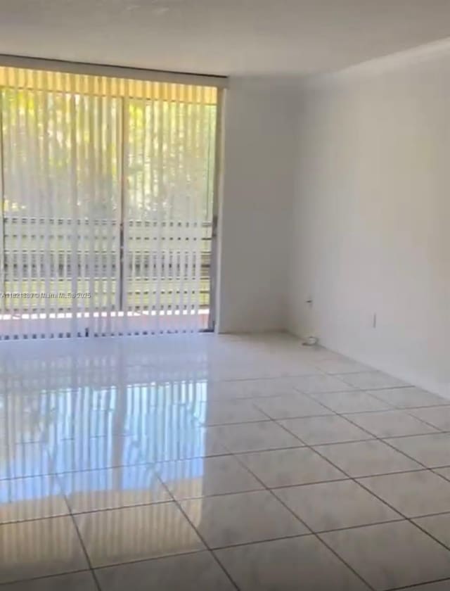 3490 Foxcroft Rd Unit B102, Miramar, FL 33025 - empty room with tile patterned flooring