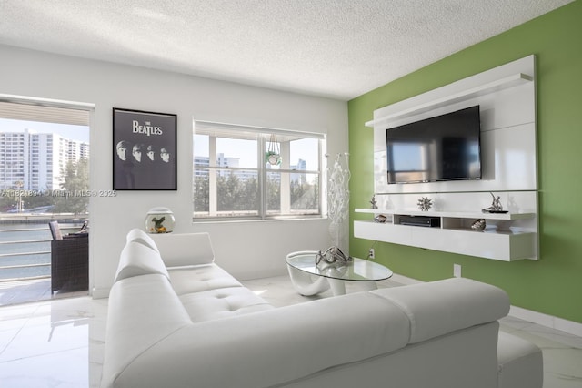 400 Diplomat Pkwy Unit 302, Hallandale Beach, FL 33009 - living room with marble look tile flooring and a textured ceiling
