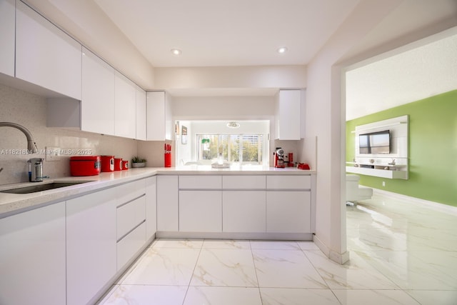 400 Diplomat Pkwy Unit 302, Hallandale Beach, FL 33009 - kitchen with light marble finish floors, light countertops, white cabinets, backsplash, and recessed lighting