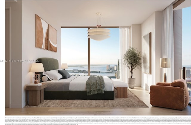 710 NE 29th St Unit 3901, Miami, FL 33137 - bedroom with wood finished floors, multiple windows, a wall of windows, and a water view