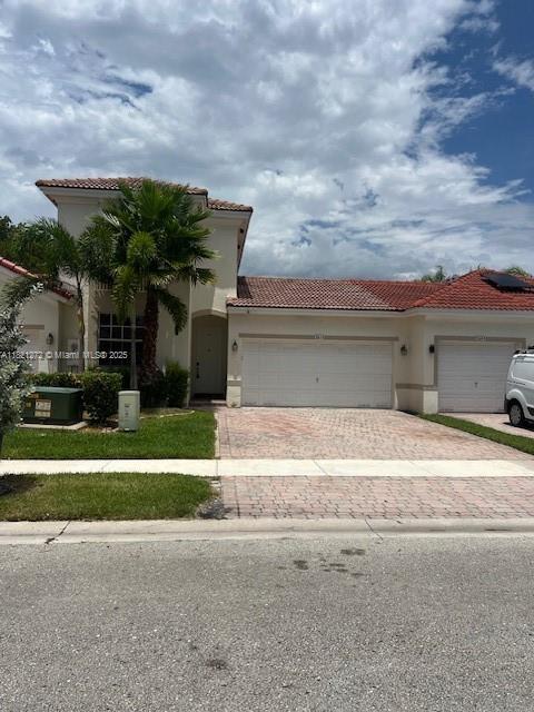 2614 SW 188th Ave, Miramar, FL 33029 - mediterranean / spanish house with a tile roof, decorative driveway, an attached garage, and stucco siding