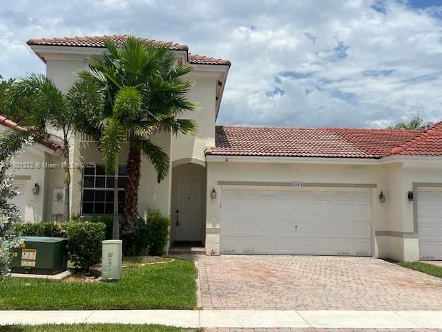 2614 SW 188th Ave, Miramar, FL 33029 - mediterranean / spanish-style home featuring a tiled roof, a garage, decorative driveway, and stucco siding