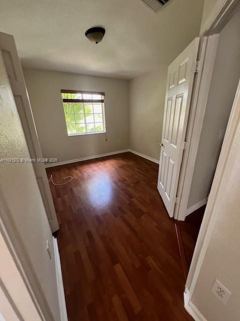 2614 SW 188th Ave, Miramar, FL 33029 - empty room with dark wood finished floors and baseboards