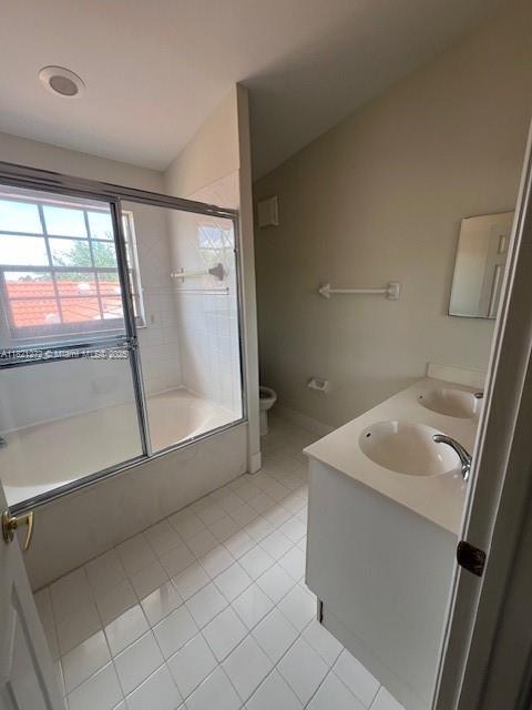 2614 SW 188th Ave, Miramar, FL 33029 - full bathroom featuring combined bath / shower with glass door, double vanity, and tile patterned flooring