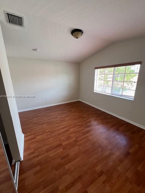 2614 SW 188th Ave, Miramar, FL 33029 - spare room with vaulted ceiling and wood finished floors