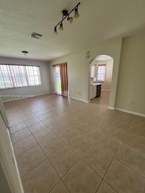 2614 SW 188th Ave, Miramar, FL 33029 - unfurnished room with light tile patterned floors, arched walkways, and track lighting