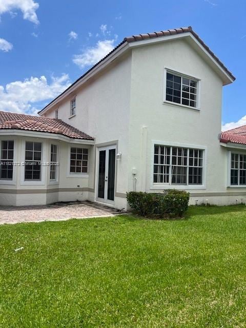 2614 SW 188th Ave, Miramar, FL 33029 - rear view of property with french doors, stucco siding, a tiled roof, and a yard