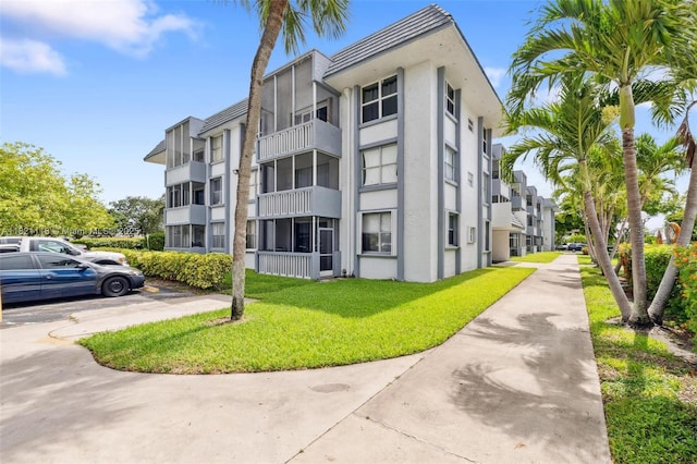6705 NW 169th St Unit C310, Hialeah, FL 33015 - view of building exterior with uncovered parking