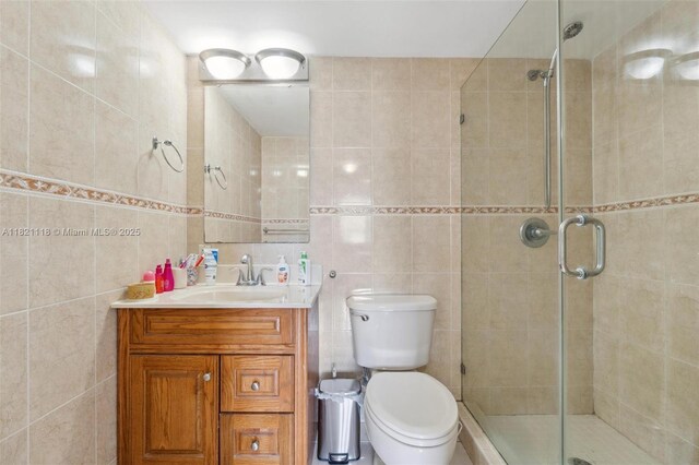 6705 NW 169th St Unit C310, Hialeah, FL 33015 - bathroom featuring tile walls, vanity, and a stall shower