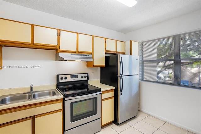 2203 SW 80th Ter Unit 2203, Miramar, FL 33025 - kitchen with appliances with stainless steel finishes, under cabinet range hood, light countertops, light tile patterned flooring, and a textured ceiling