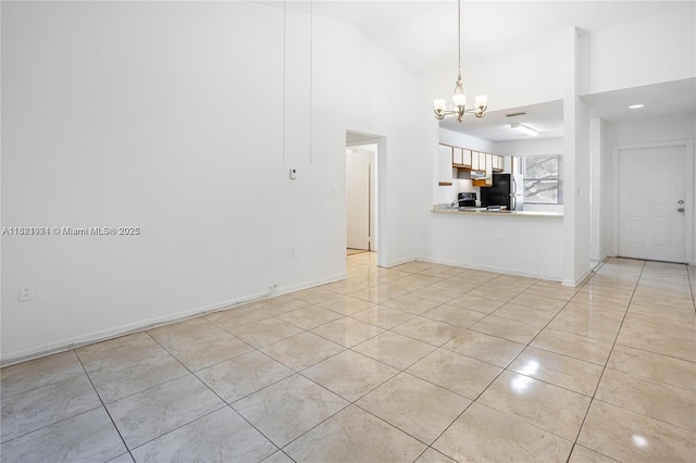 2203 SW 80th Ter Unit 2203, Miramar, FL 33025 - unfurnished living room with a chandelier, light tile patterned floors, and high vaulted ceiling